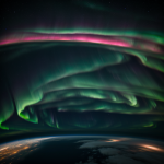 A stunning view of the aurora borealis from the International Space Station, showcasing vibrant colors in the Earth's atmosphere.