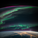 A breathtaking view of the aurora illuminating Earth as seen from the International Space Station, showcasing nature's mesmerizing light show.