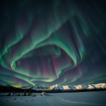 A breathtaking view of the aurora stretching across the horizon, showcasing vibrant colors and natural beauty in the night sky.