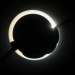 A futuristic dome city nestled under the glowing rings of Saturn, illustrating a blend of advanced architecture and cosmic beauty.