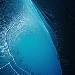 A frozen alien ocean with glowing cracks in the ice, revealing a mysterious and captivating extraterrestrial landscape.