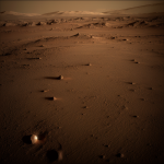 Phobos casting its shadow on the surface of Mars, illustrating the dynamic celestial interaction between the Martian moon and the red planet.