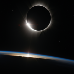 A breathtaking view of a solar eclipse captured from space, showcasing the moon passing between Earth and the sun, casting a shadow over the Earth.