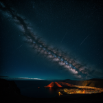 A mesmerizing view of a volcanic island glowing warmly under a clear, star-filled night sky, offering a breathtaking natural spectacle.