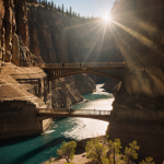 A beautiful bridge stretches across a vast canyon, illuminated by the golden rays of sunlight, creating a tranquil and picturesque scene.