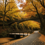 A scenic view of a forest bridge covered in vibrant autumn leaves, surrounded by colorful trees, offering a peaceful and picturesque nature escape.