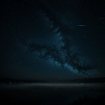 A breathtaking view of glowing constellations enveloped in mist, creating a mystical and ethereal night sky scene perfect for stargazing enthusiasts.