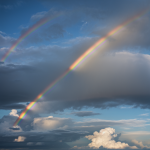 A stunning rainbow arches across the sky, casting vibrant colors after a storm, showcasing nature's beauty and the atmospheric phenomena that create this spectacle.