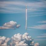 A powerful rocket launching through thick clouds, illustrating the awe-inspiring moment of space exploration and technological advancement.