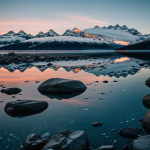A stunning view of Glacier Bay at sunset, capturing the fiery sky's reflection on the tranquil icy waters, a perfect scene for nature and photography lovers.