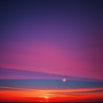 A stunning gradient sunset horizon with vibrant colors seamlessly blending across the evening sky, capturing the magic and tranquility of nature's masterpiece.