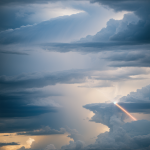 A stunning scene of light beams piercing through dark thunderclouds, creating a dramatic contrast and showcasing the beauty of nature's phenomena.