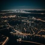 A stunning aerial view of a city at night, showcasing the vibrant city lights and skyline, capturing the essence of urban life after dark.