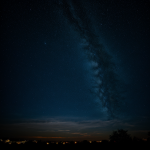 A breathtaking view of the night sky with glowing clouds, creating a magical and ethereal atmosphere perfect for stargazing enthusiasts.